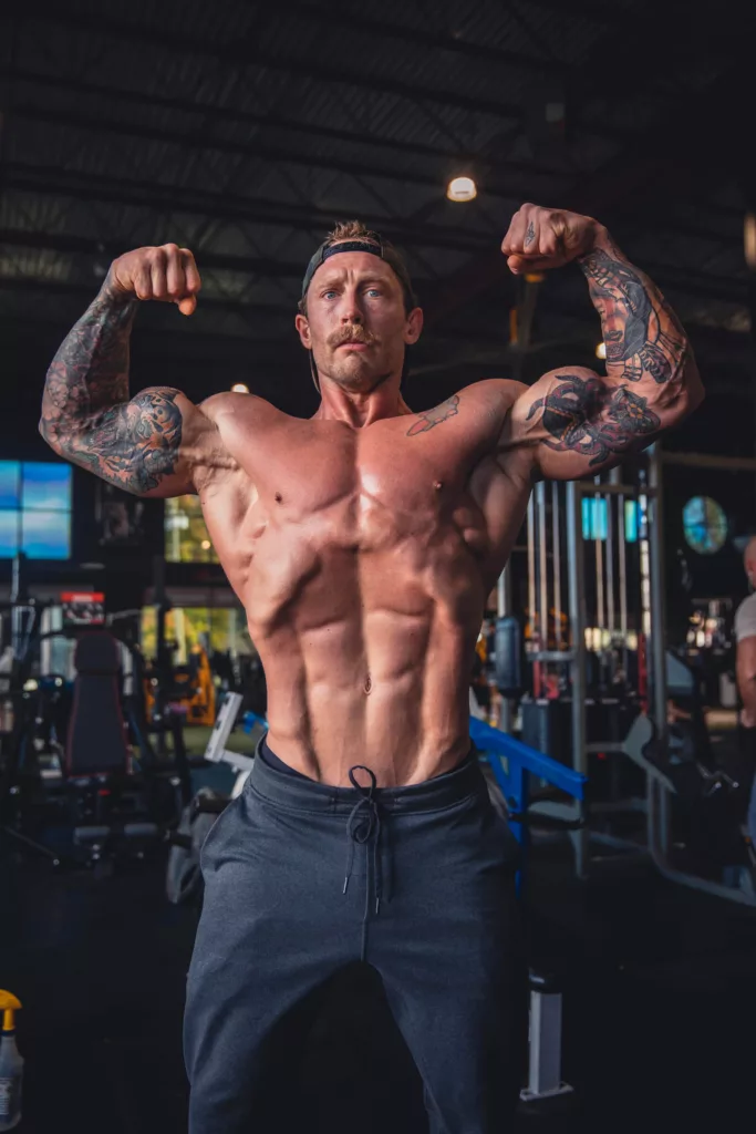 Athlete hitting a front double bicep and making the most of these posing tips!